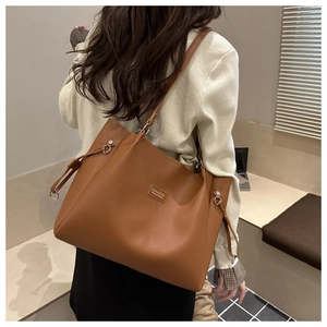 Detailed back view of a large brown tote bag with premium leather texture and drawstring