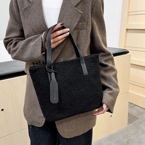 Fuzzy black fleece tote bag for women with leather handles in autumn fashion style