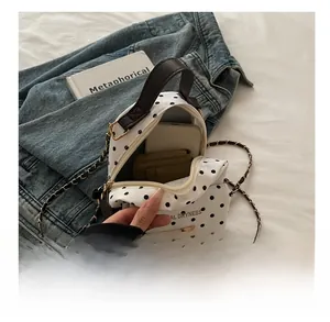 Polka dot mini backpack interior showing capacity for smartphone and card holder