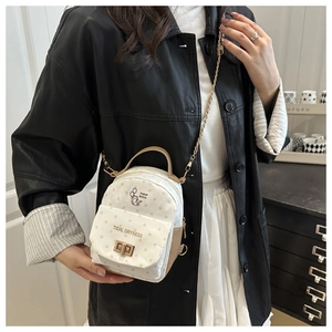 Polka dot mini backpack featuring cat pattern and elegant golden chain strap