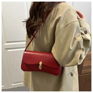 Detailed macro view of the premium red lychee textured leather bag and golden U-shaped lock