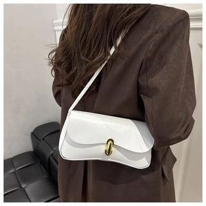 Detail of white leather shoulder bag featuring a golden oval twist lock and smooth finish