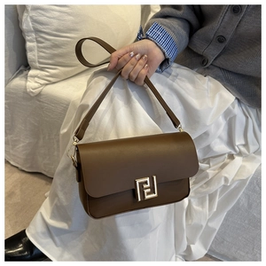 Detailed view of dark brown faux leather bag with elegant gold geometric metal buckle