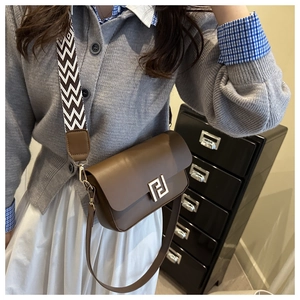 Brown leather crossbody bag with geometric gold buckle and stylish wide woven strap