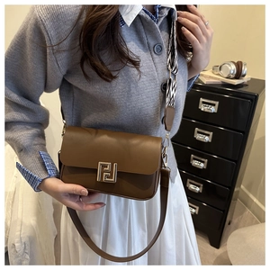 Brown leather crossbody bag with golden geometric metal buckle and dual straps