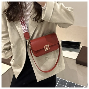 Red matte leather crossbody square bag with gold geometric lock and wide patterned strap