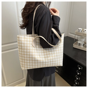 Chic houndstooth tote bag shown on model featuring beige and white patterns for daily commute