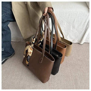 Close-up of high-capacity tote bags in four colors with contrast stitching and silk scarf