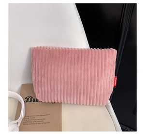 Pink corduroy envelope clutch bag with striped texture and fashion side label