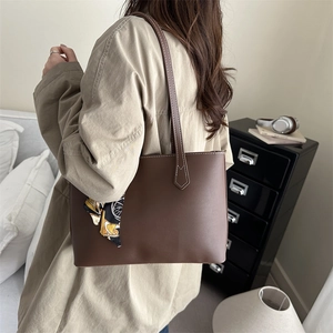 Minimalist large brown tote bag with contrast stitching and floral silk scarf detail