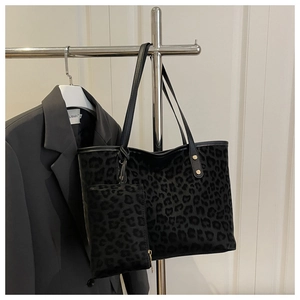 Detailed view of leopard print tote bag with small matching pouch and leather handles