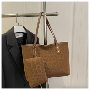 Close-up of brown leopard print tote bag with matching pouch and brown leather handles