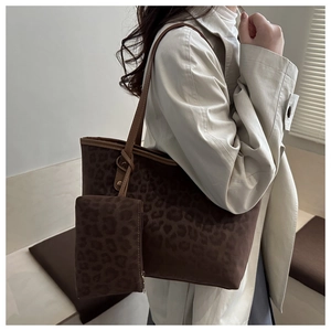 Detailed view of dark brown leopard print tote bag with a matching small zip pouch