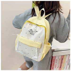 Detail of yellow and white backpack with transparent front pocket and cute cartoon prints