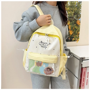 Close-up of cute school backpack with transparent pocket and decorative badges