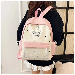 Detail of cute pink and cream backpack with transparent front pocket and cartoon prints