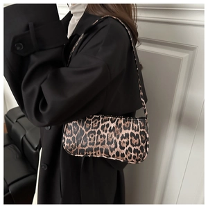 Chic leopard print baguette shoulder bag shown on model for a trendy autumn urban look