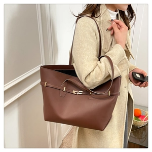 Detail of vintage brown tote bag featuring gold twist lock and slim shoulder straps