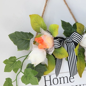 Floral Home sign with white and orange roses, green leaves, and black striped bow