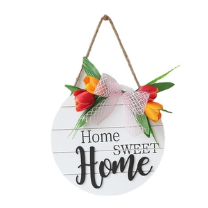 White wood welcome sign with Home Sweet Home text, tulips and a plaid bow