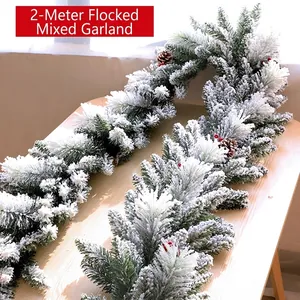 Close-up of a 2m flocked mixed Christmas garland with pine cones and red berries