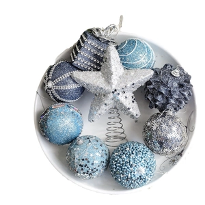 Blue and silver Christmas ball ornaments set with star topper in a white plate