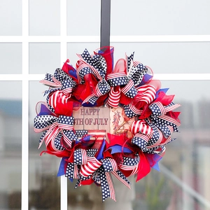 Patriotic 4th of July door wreath with American flag ribbons and a happy wood sign