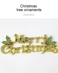 Detail of golden Merry Christmas sign with green holly leaves and red berries
