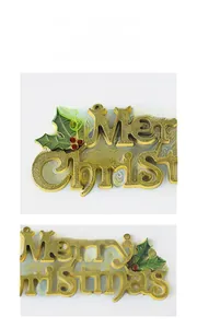 Detail of golden Merry Christmas sign with green holly leaves and red berries