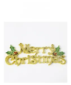 Close-up of glittery golden Merry Christmas sign with red berries and green holly leaves