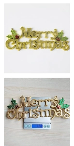 Detailed weight measurement of a golden Merry Christmas hanging ornament on a scale