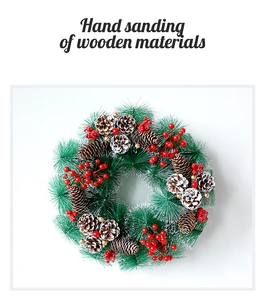 Détail de couronne de Noël avec pommes de pin, baies rouges et bois poncé à la main