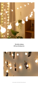 Detail showing warm white LED globe string lights with wooden photo clips for holiday decor