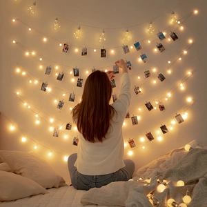 Cozy bedroom wall decor with warm LED ball lights and clips for hanging photos