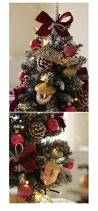 Detail of 45cm snowy Christmas tree with red velvet bows and warm LED lights
