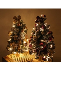Detail of 45cm mini Christmas trees with warm LED lights and festive gold or red ornaments
