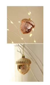 Detailed view of hazelnut Christmas ornaments with white snowflake patterns and glitter tops