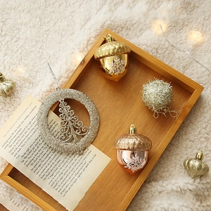 Elegant hazelnut and glitter ball ornaments set on wooden tray for Christmas tree decor