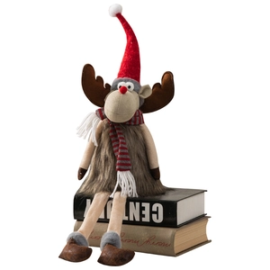 Weihnachts-Rentier-Plüschfigur mit roter Mütze und Schal auf Büchern für Heimdekoration