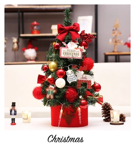 Close-up of luxury 45cm desktop Christmas tree with red bows and festive LED ornaments