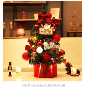 Close-up of a decorated 60cm Christmas tree with LED lights and plush ornaments