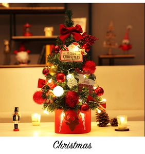 Mini tabletop Christmas tree with LED lights and red reindeer base for holiday decor