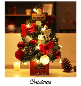 Close-up of 60cm mini Christmas tree with red bows, ornaments and LED lights on gift box base