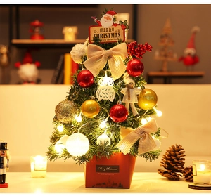 Close-up of 45cm mini Christmas tree with red gold baubles and warm LED fairy lights