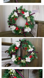 Close-up of Christmas wreath with pine cones, red berries and cotton balls on wood