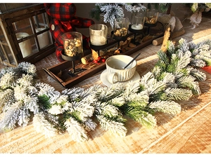 Detail of 1.8m flocked PE Christmas garland with realistic artificial snow on green pine needles