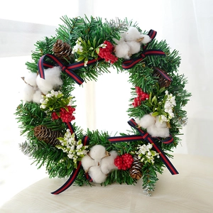 Festive Christmas wreath with pine cones cotton balls red berries and striped ribbon bow