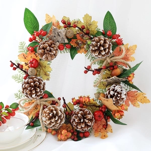 Detailed close-up of autumn wreath with pine cones, red berries, and maple leaves