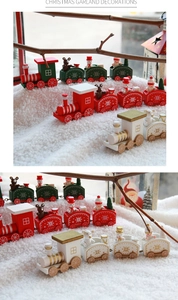 Close-up of wooden Christmas train set with snowman and bear dolls in a snow scene
