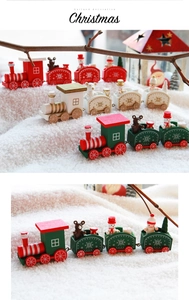 Detail of wooden Christmas train decor with snowman and bear figures on white snow